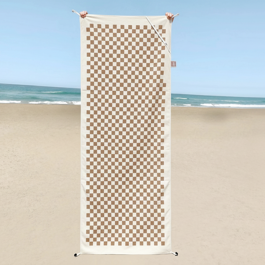 A neutral checkered pattern feels timeless and versatile, reminiscent of classic picnic or vintage-inspired designs adapted for a beach setting.