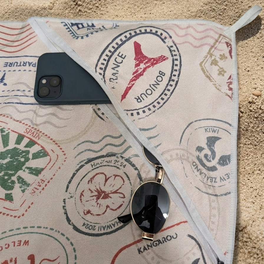 It looks lightweight and smooth—perfect for use as a sand-free beach towel—and has a casual, adventurous aesthetic that matches the “voyager” theme.